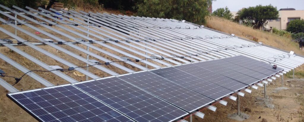 Solar panels on a residential roof, providing clean energy. Groundscrew installation for solar fencing.